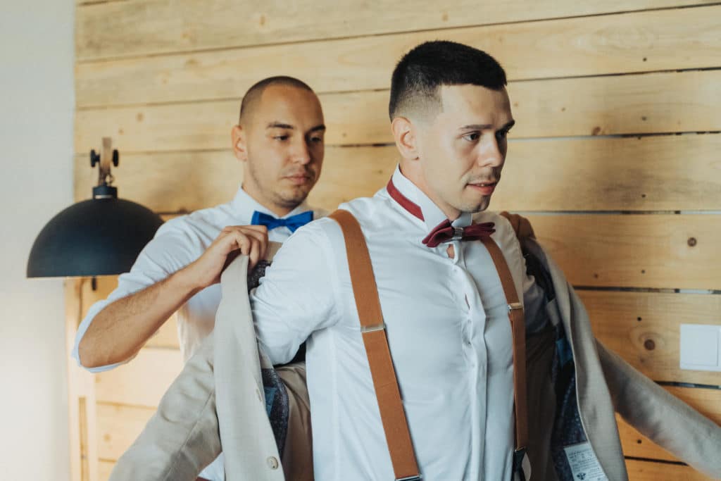 ženích si oblieka svadobný oblek